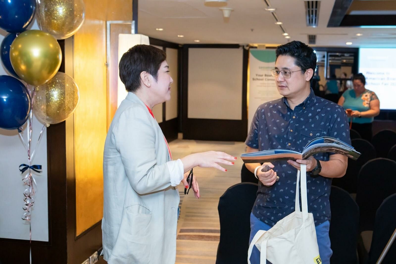 A boarding school representative and a parent discussing at the American Boarding School Fair by Sesameed Education 2023 in Bangkok