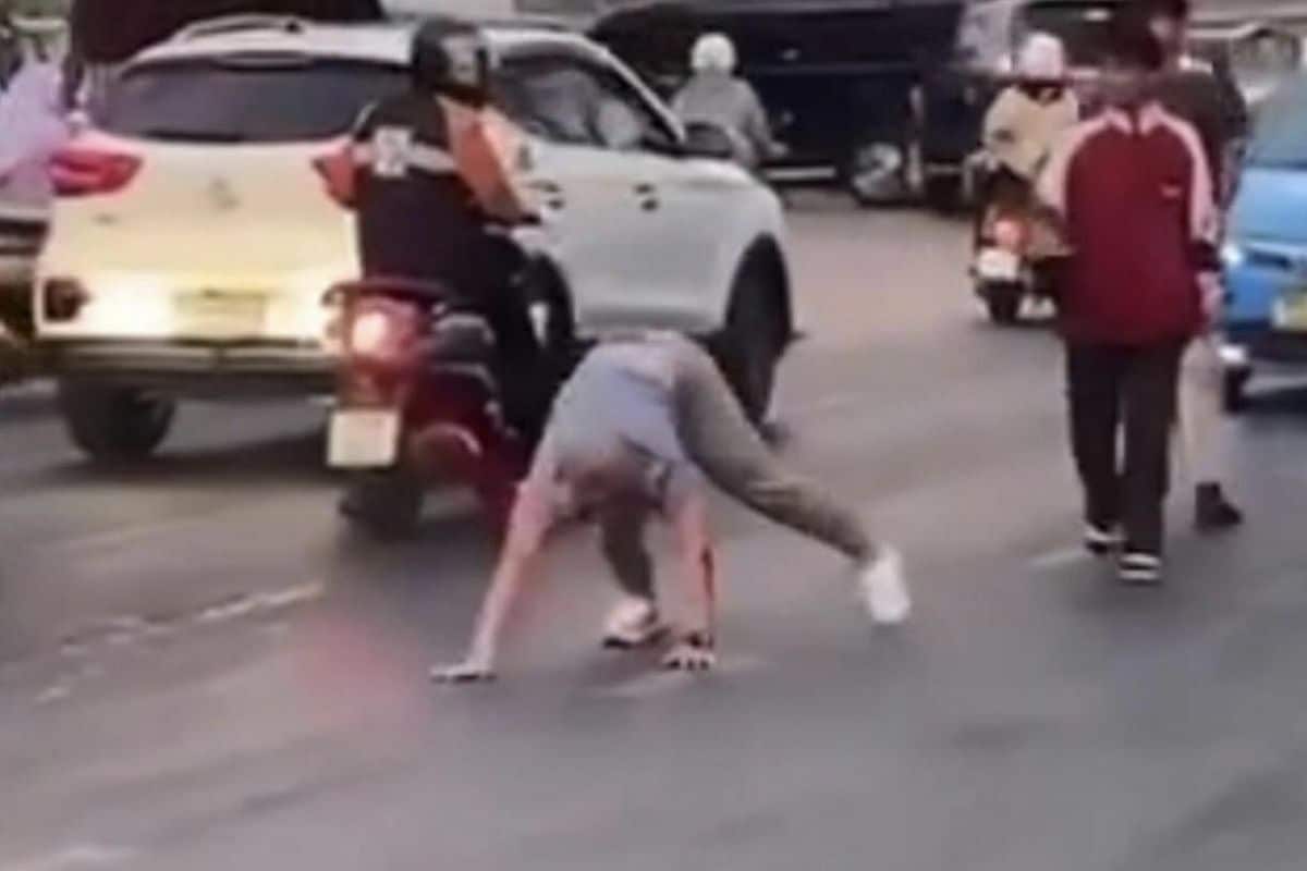 Drunk foreign man crawls on Bangkok road, causing traffic jam