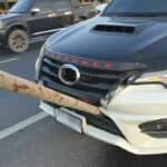 Elongated log damages car radiator on Thai bypass road