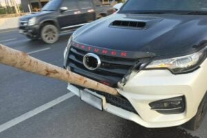 Elongated log damages car radiator on Thai bypass road