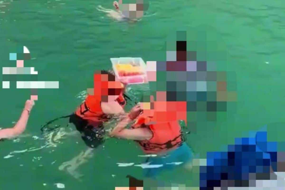 Thai tour guide offers fruits to tourists in sea sparking criticism