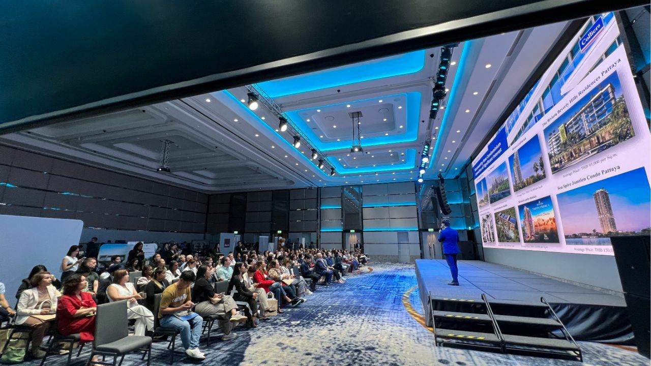 Audience watching a presentation at the event dot property