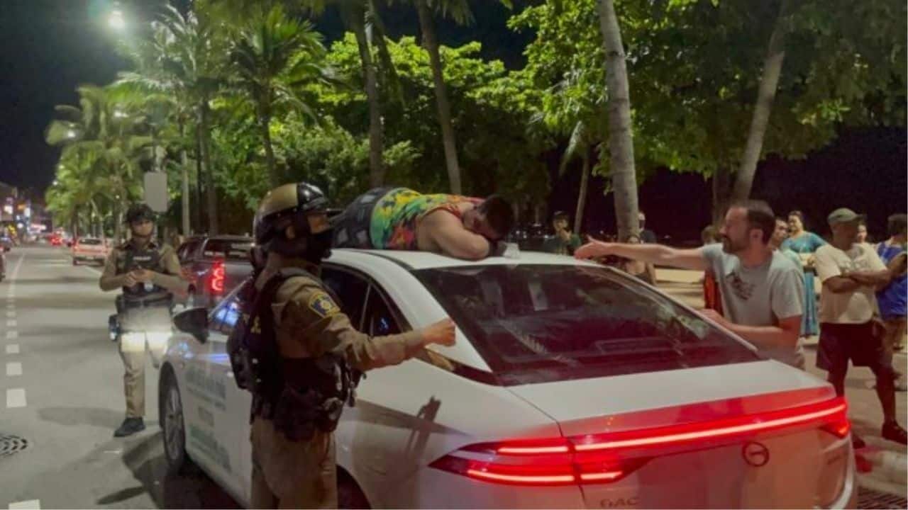 Drunk Indian tourist climbs taxi roof in Pattaya beach meltdown