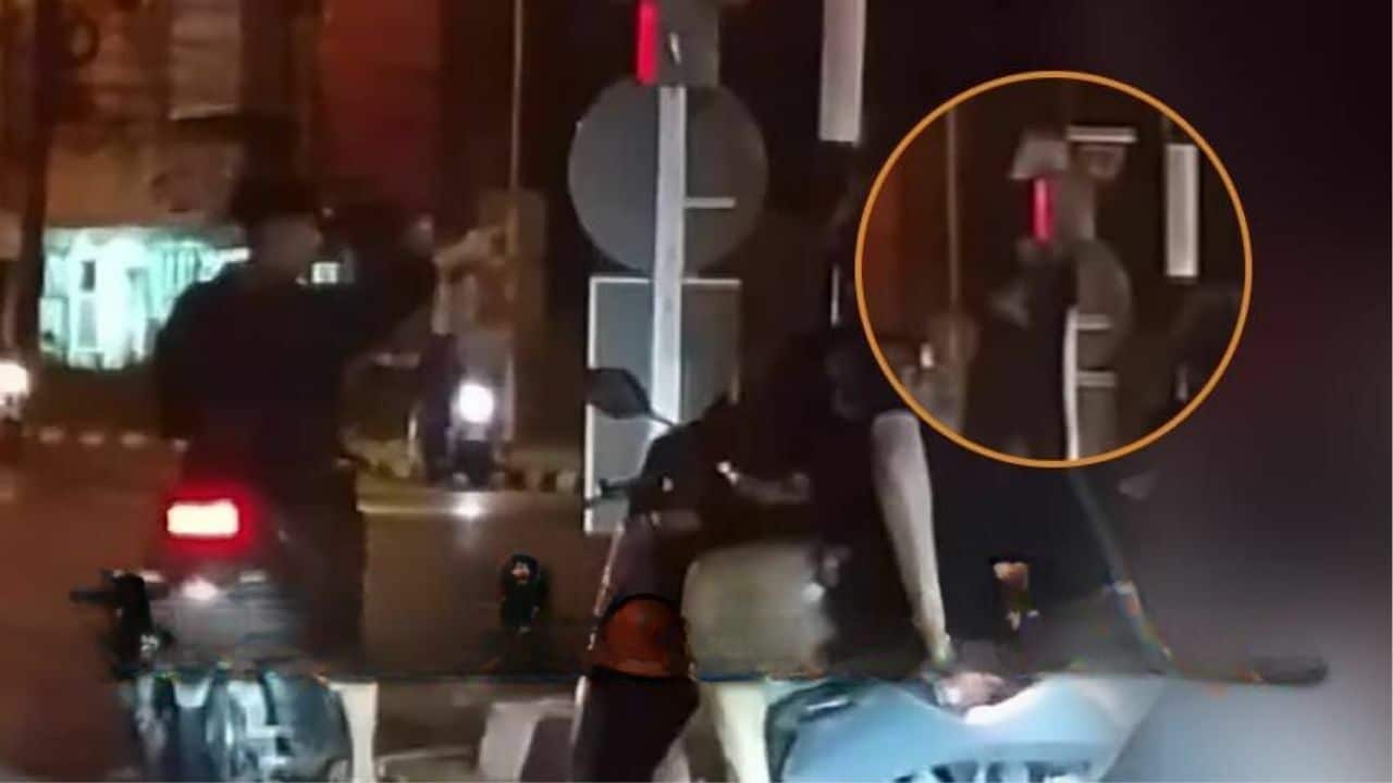 Phuket red mist: Daft foreign tourist climbs traffic light to go green