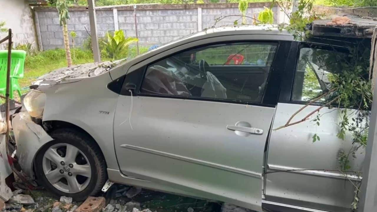 Foreign man crashes car through local house's wall