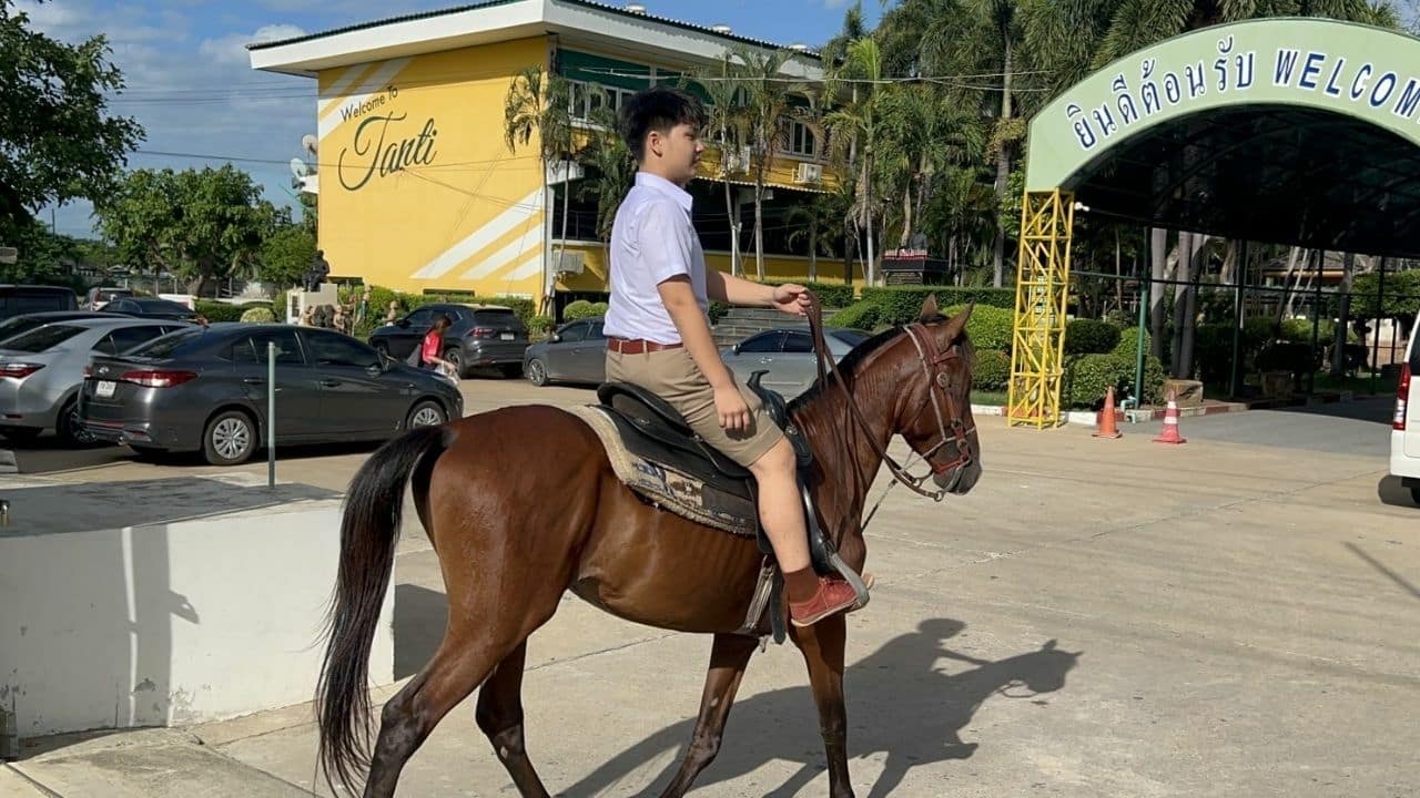 Thai teen rides horse to school