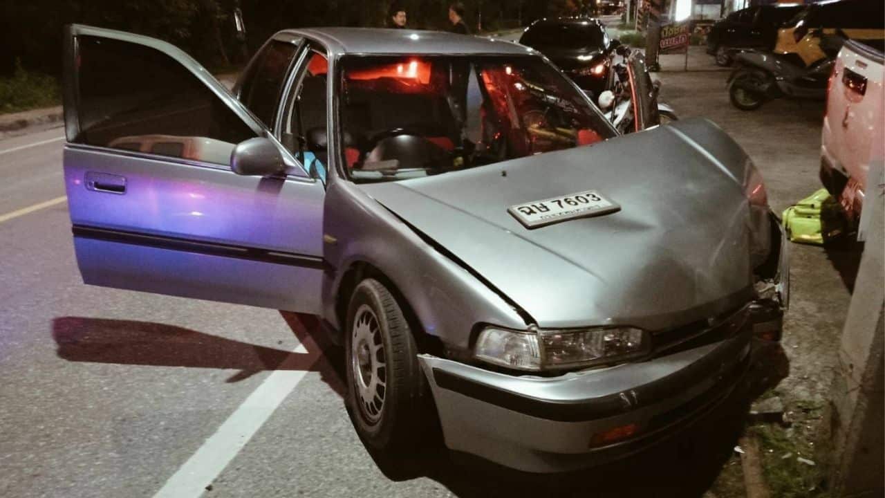 Thai man protects drunk girlfriend who crashes car into pole