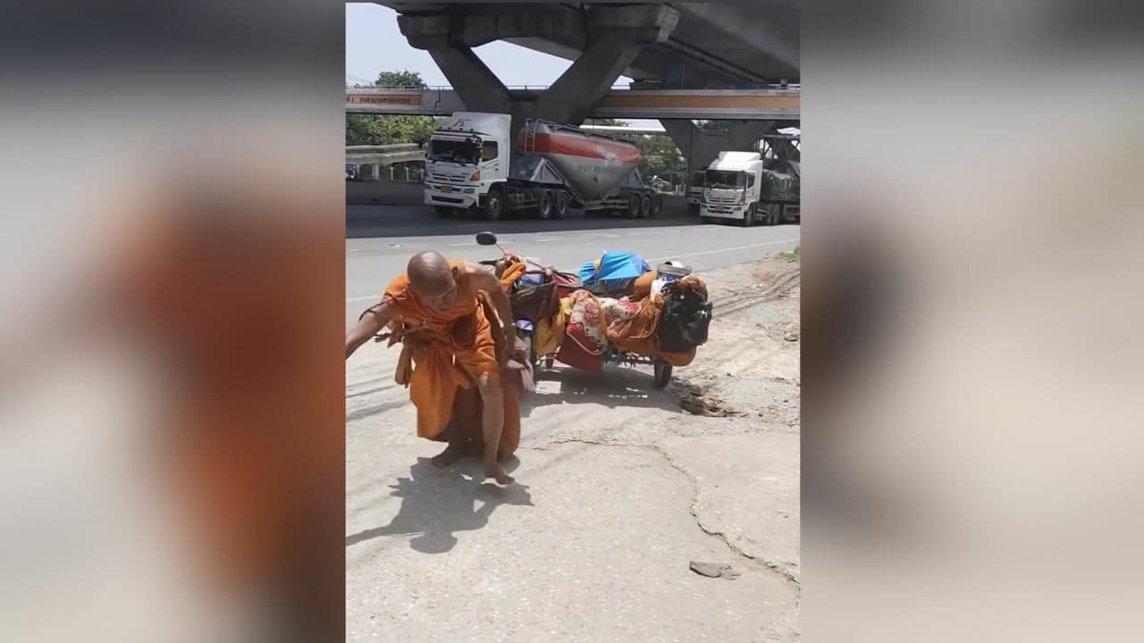 Imposter monk drags motorcycle along road in Korat (video)