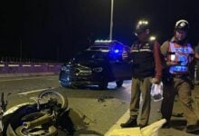 Motorcycle crash with Mercedes-Benz kills two young men in Pathum Thani