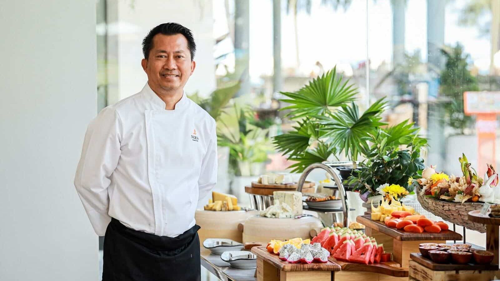 Executive chef at brunch buffet with frsh tropical fruit and cheese at Nora Beach Club Phuket, Thailand