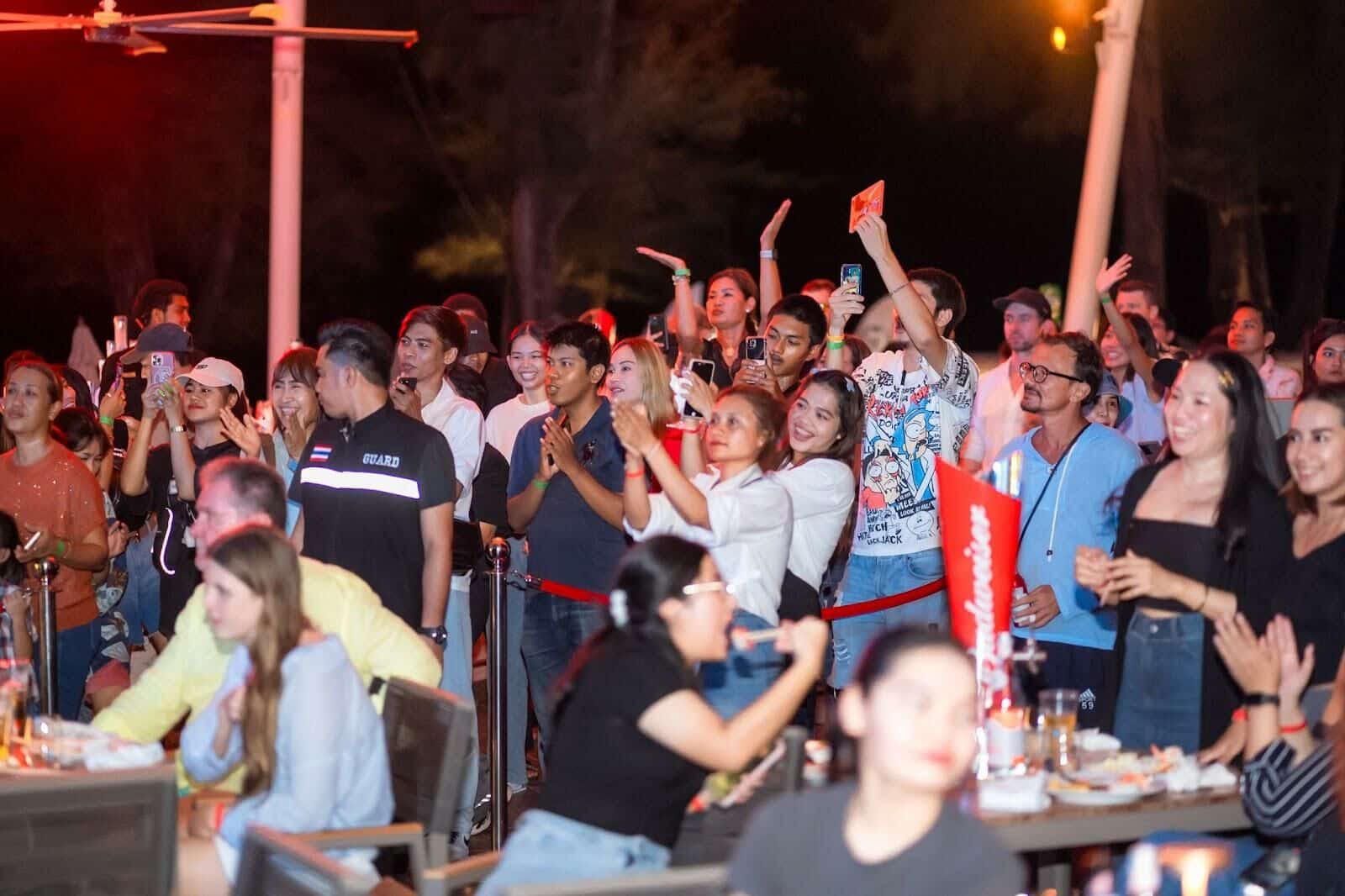 Crowd enjoying a live music event at a beach club in Phuket, Thailand