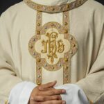 Eucharistic motifs on liturgical vestments: chalice, host, and grapes | Thaiger