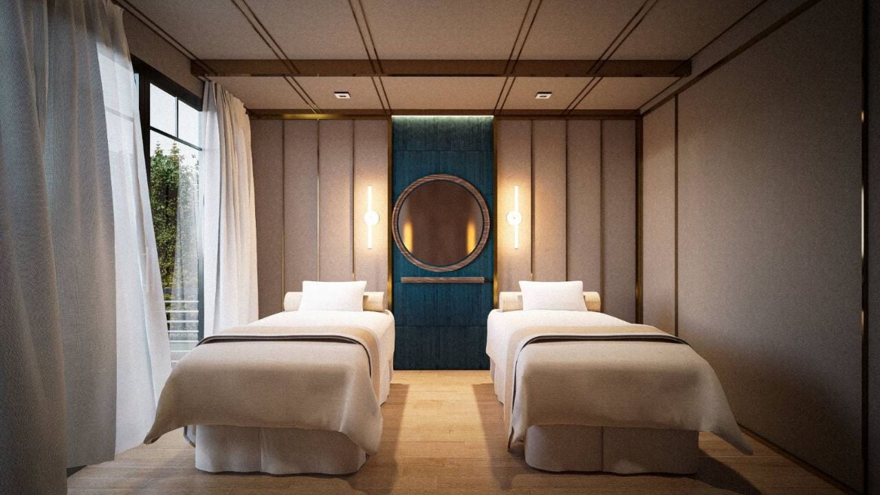 Double spa beds in a warm, softly lit wellness room.
