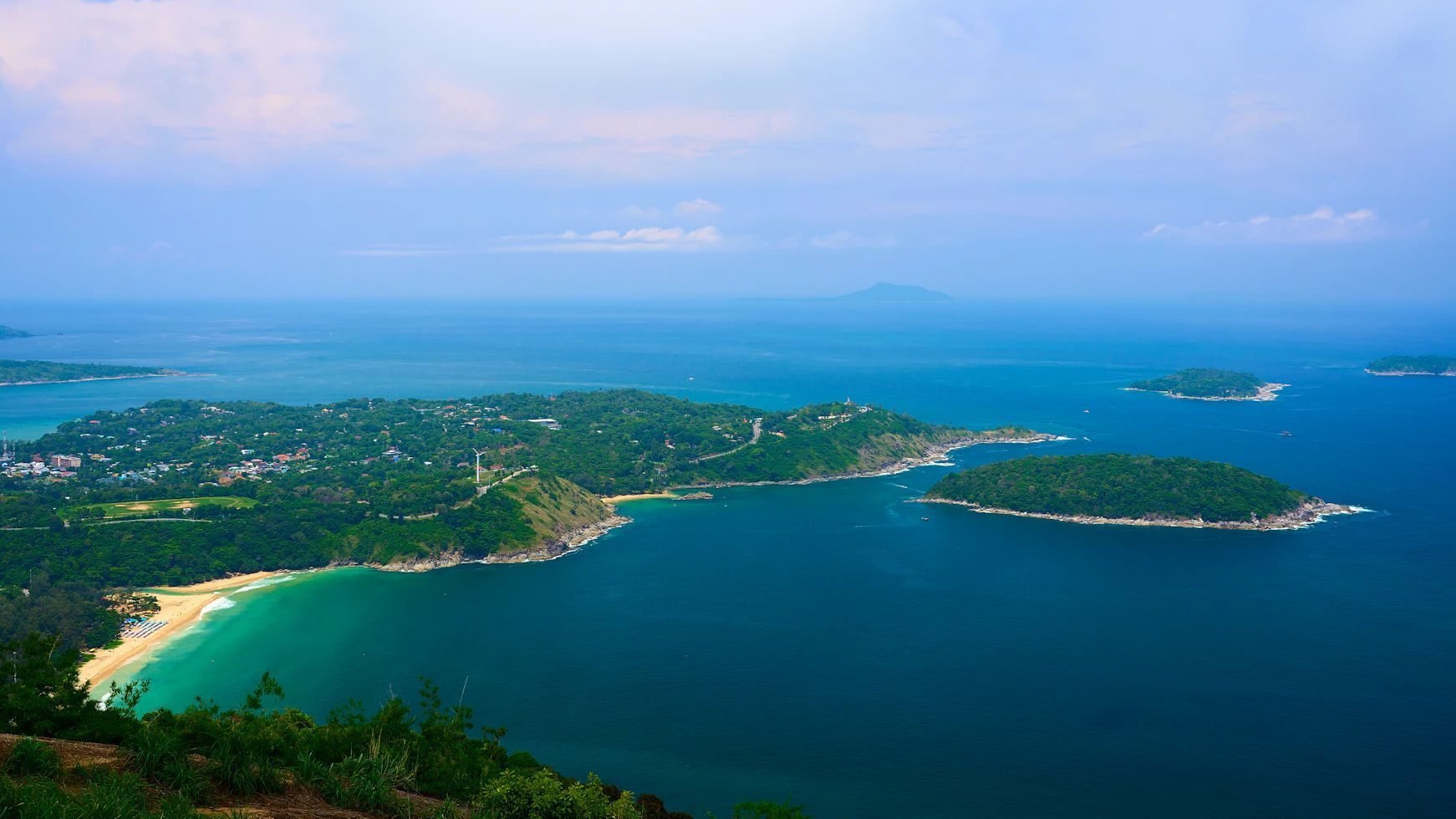 Scenic view from Promthep Cape overlooking turquoise waters and green islands.
