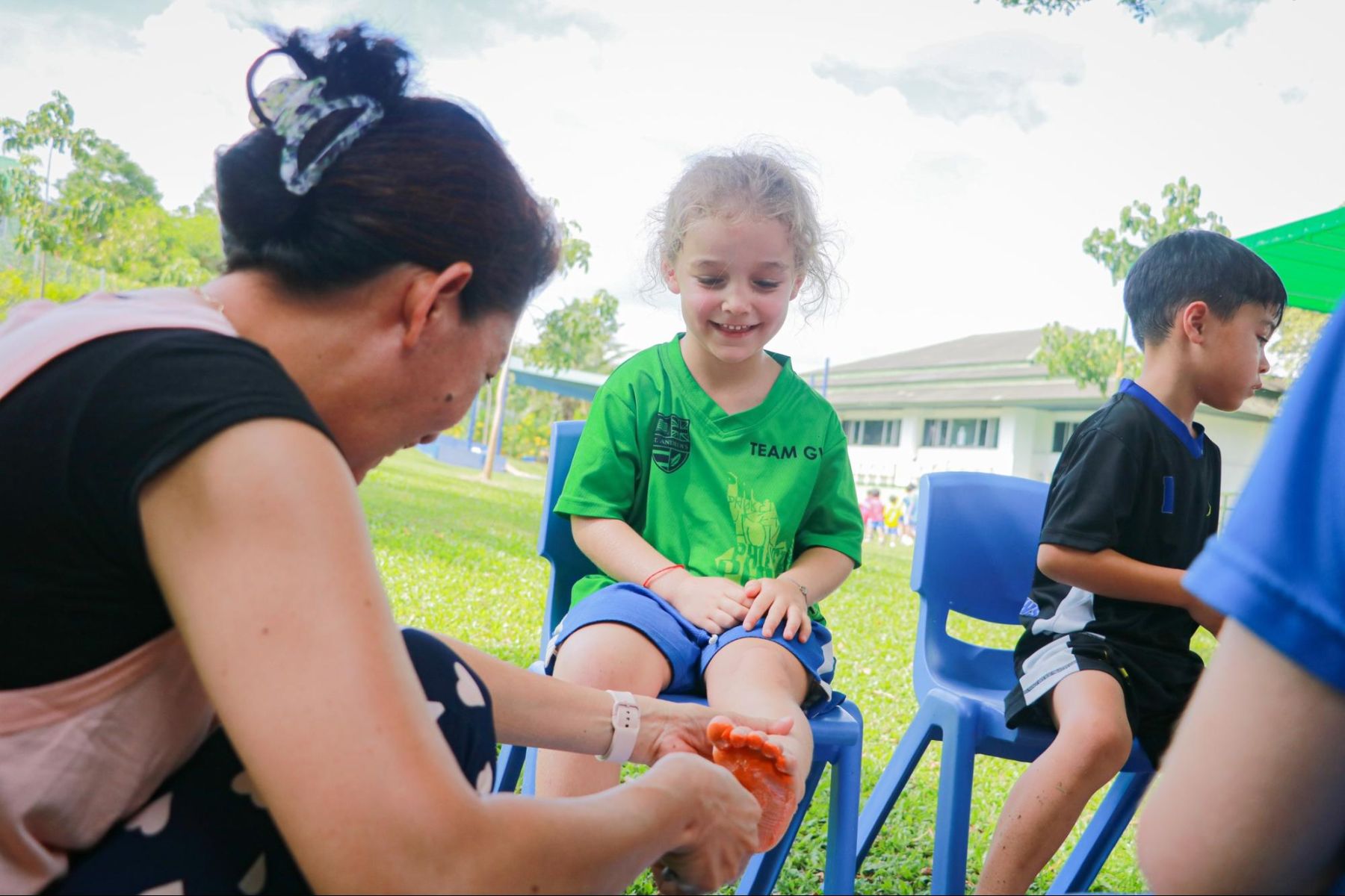 A student smiling with a teacher at St. Andrews International School, Green Valley