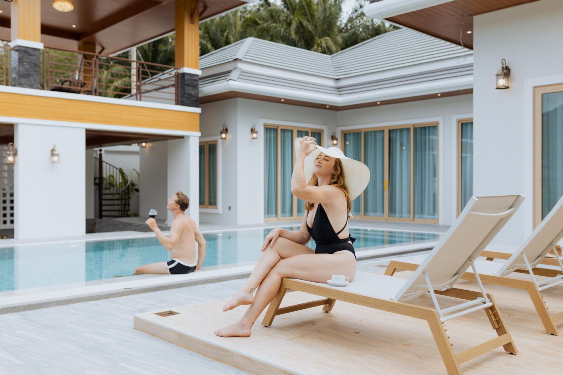A couple enjoying the pool at their villa
