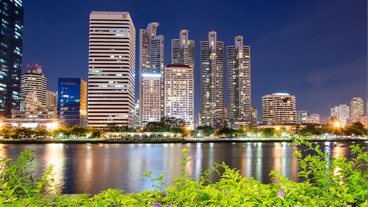 Riverside condominiums in Bangkok offering 1-bedroom units with stunning city views.