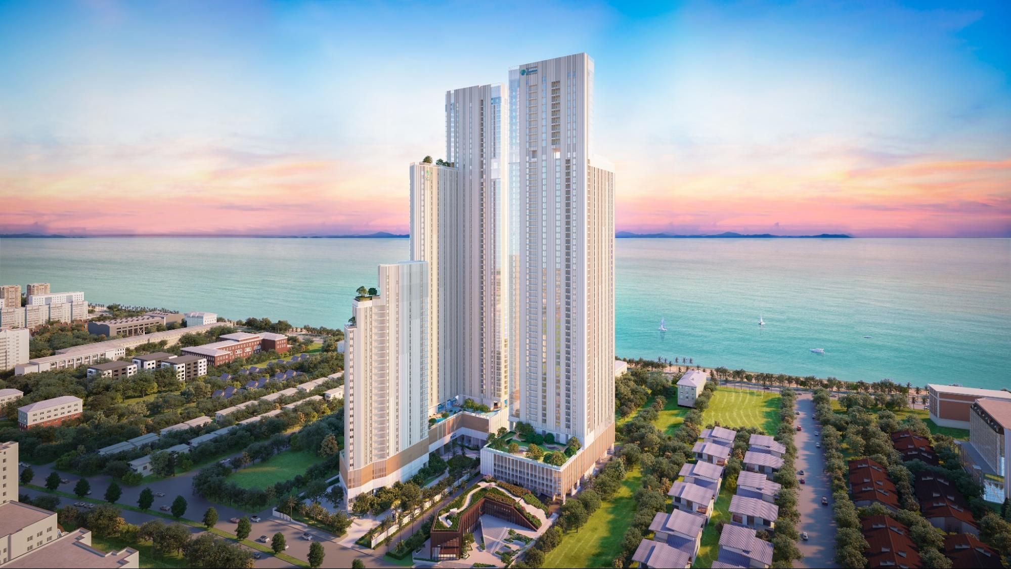 Aerial view of Skypark Lucean Jomtien towers with sea and sunset backdrop.