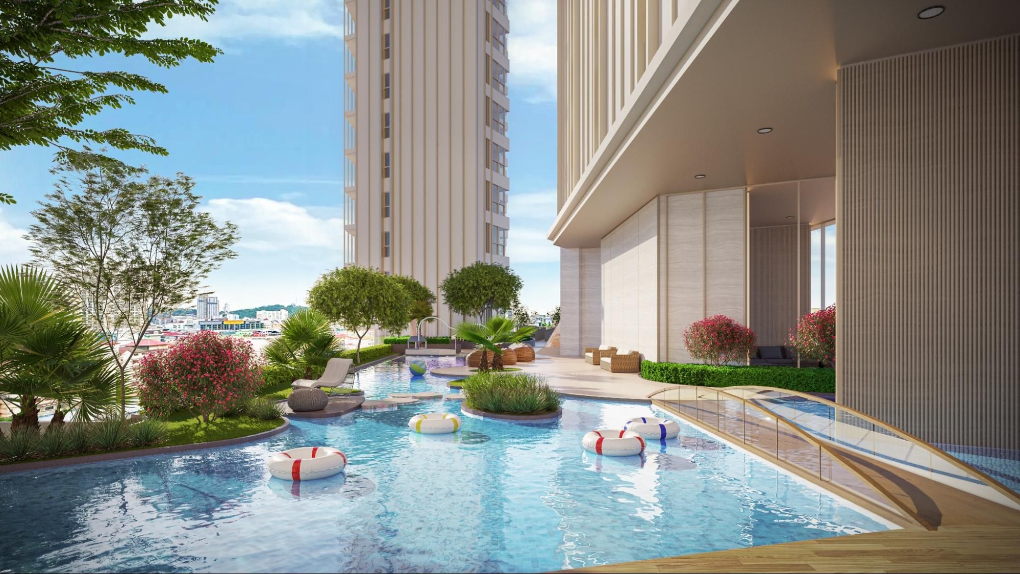 Outdoor swimming poll with landscaped garden at a Pattaya condominium.