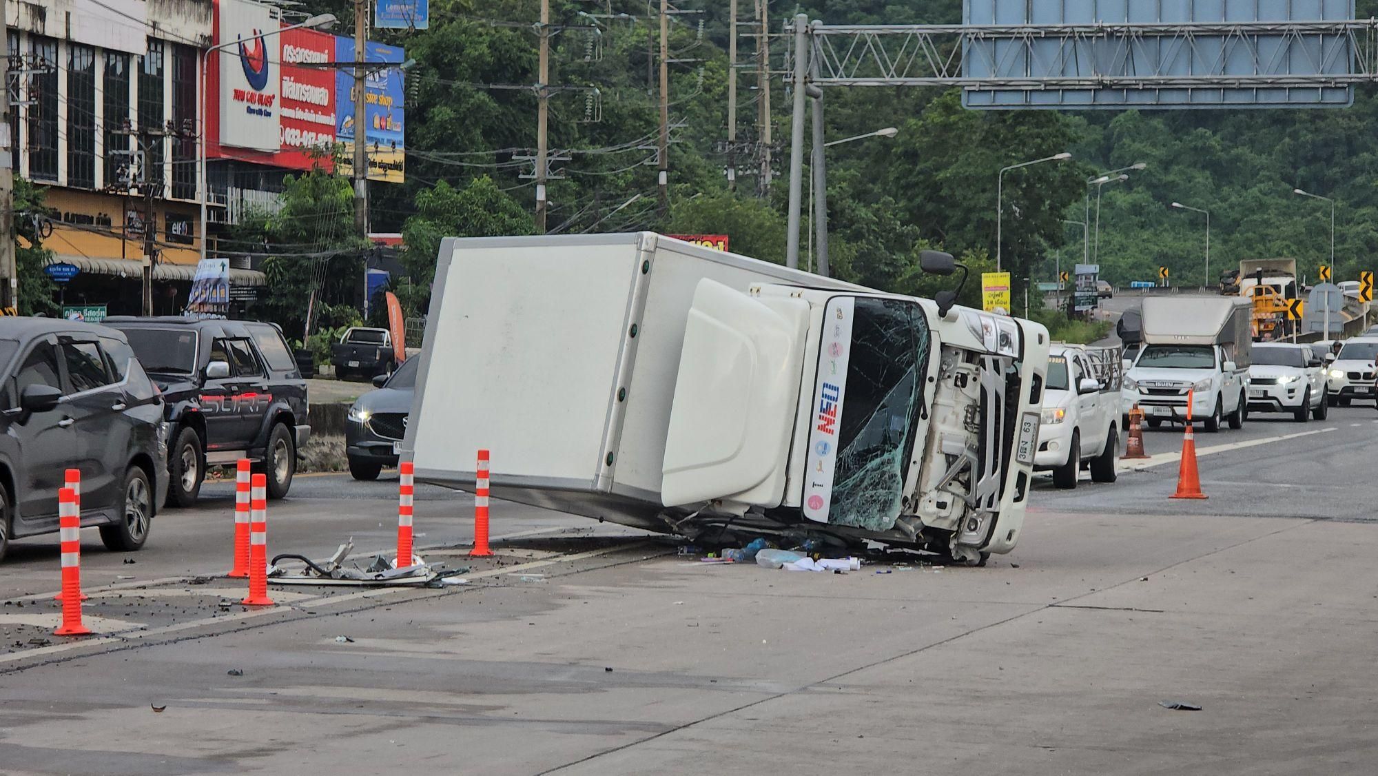 Delivery truck flips on wet Sri Racha road, driver injured | News by Thaiger
