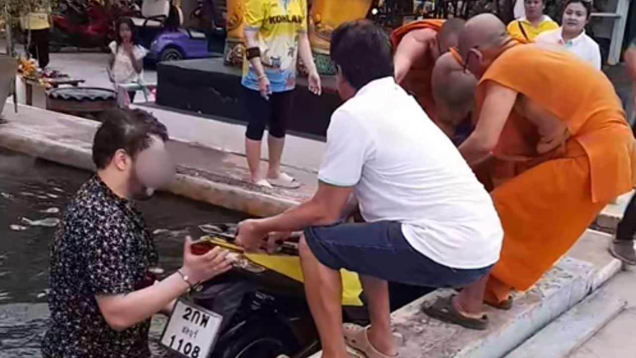 Man goes viral after accidentally riding motorcycle into temple pond | Thaiger