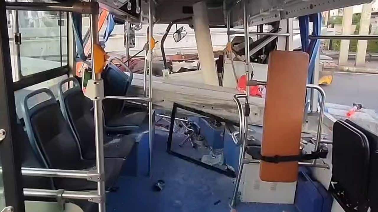 Bus crashes truck carrying concrete piles
