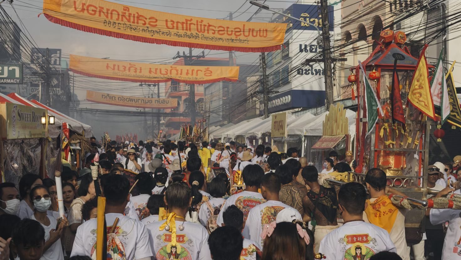 a group of people standing around a float during Phuket Vegetarian Festival in Phuket