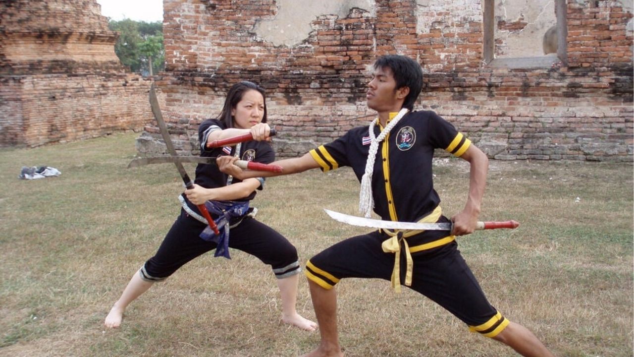 Two martial artists using daab (swords) while practicing Krabi Krabong | Photo taken from the Traditional Sports website
