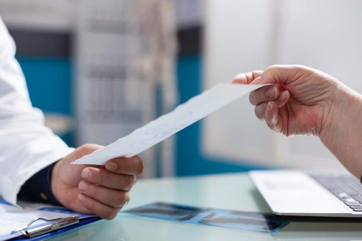 Documentation being organized for insurance claims after medical treatment in Thailand.