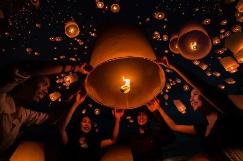 People enjoying the Yi Peng Festival with floating lanterns in Chiang Mai
