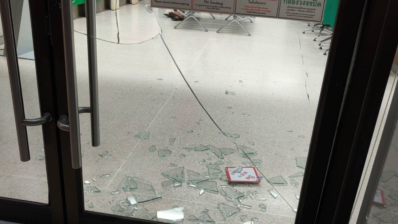 Thai man wants jail so breaks bank glass door