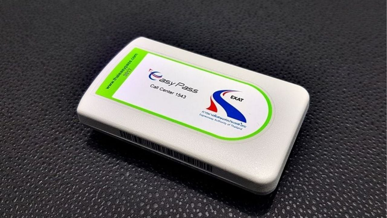 Electronic toll tag for Easy Pass displayed on a car's windshield in Thailand.