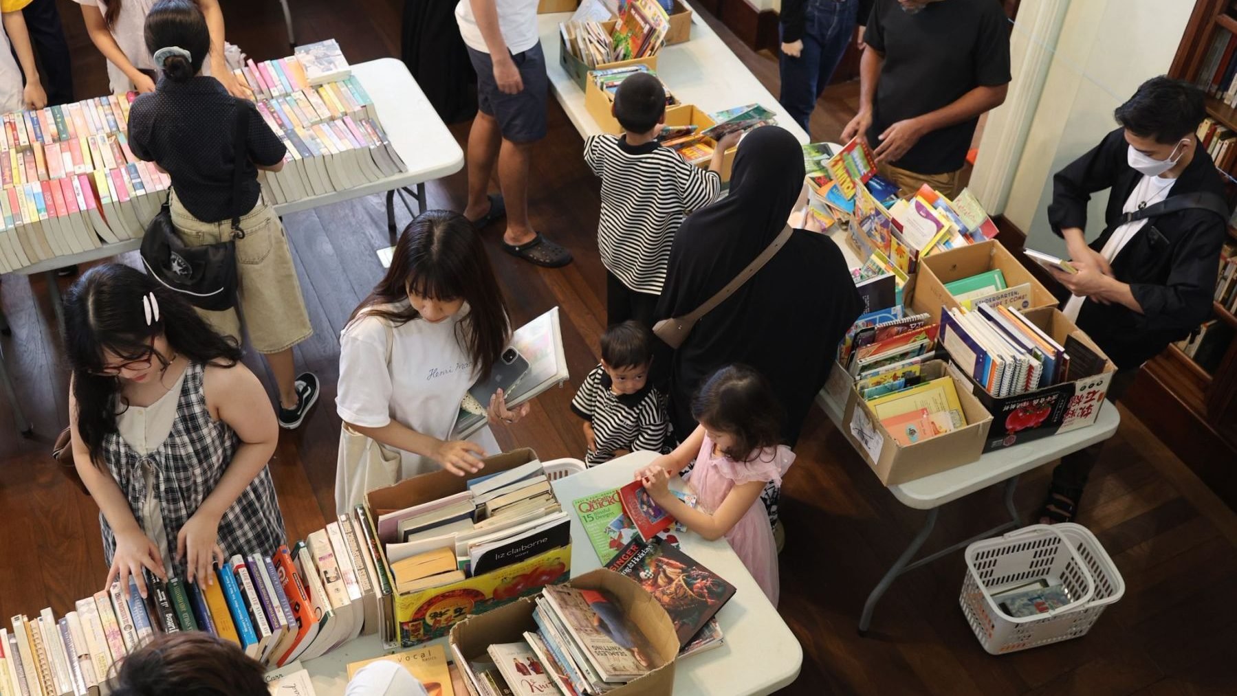 People browsing books at Neilson Hays Library Bi-Annual Book Sale, Bangkok