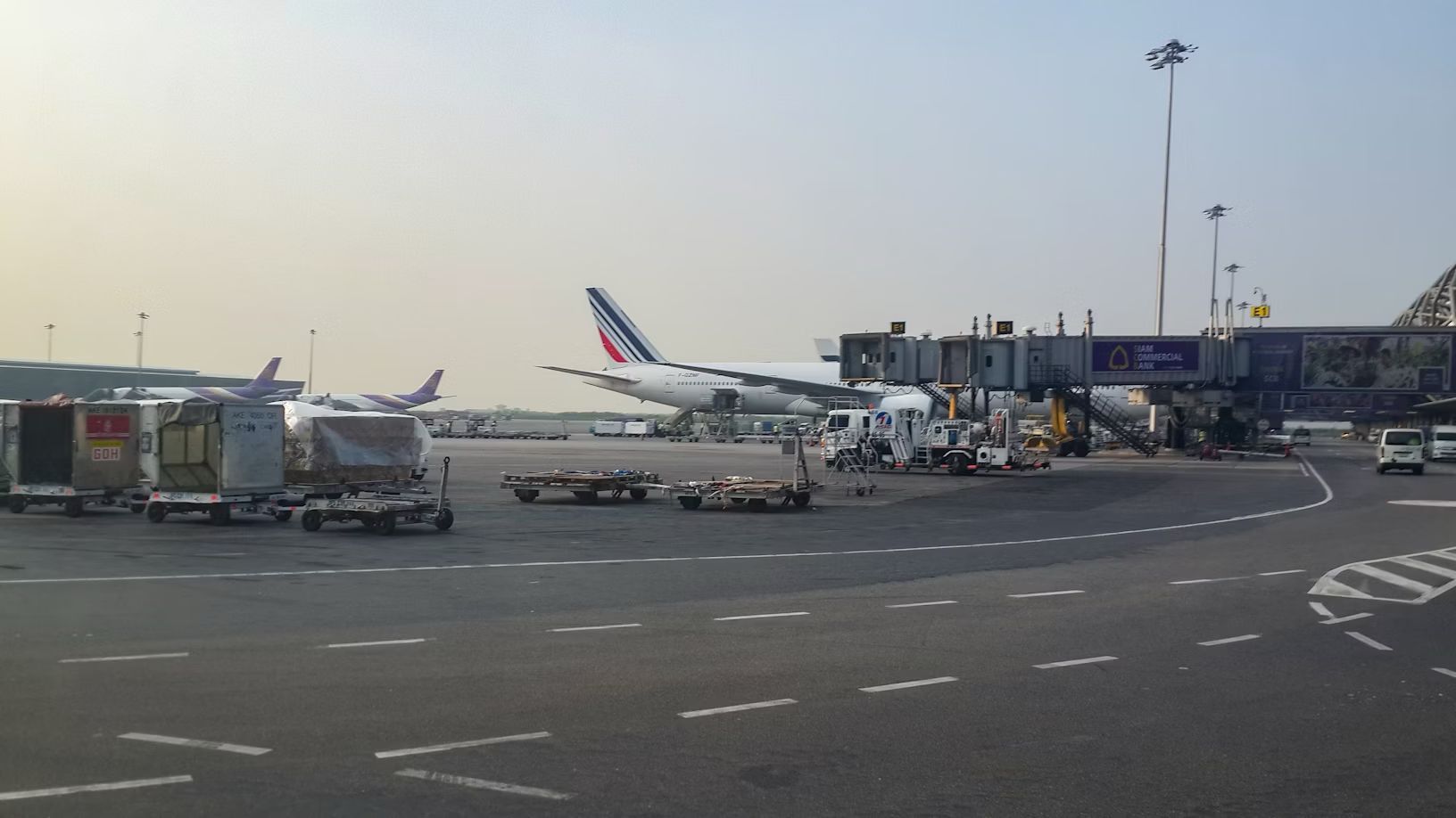 a large jetliner sitting on top of an airport tarmac at Bangkok Suvarnabhumi international airport, Thailand