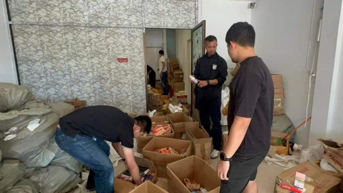 Authorities inspect the commercial unit in Boat Plaza used for the scam operations.