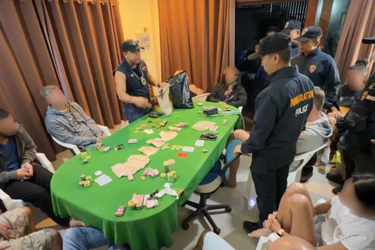 Police officers at the scene of an illegal poker raid in Koh Phangan, Surat Thani