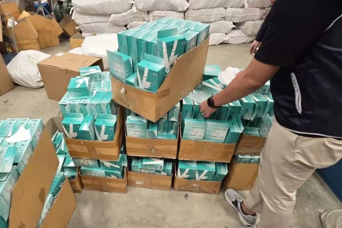 Boxes of counterfeit Welcare face masks and fake cosmetics seized from a warehouse in Samut Prakan