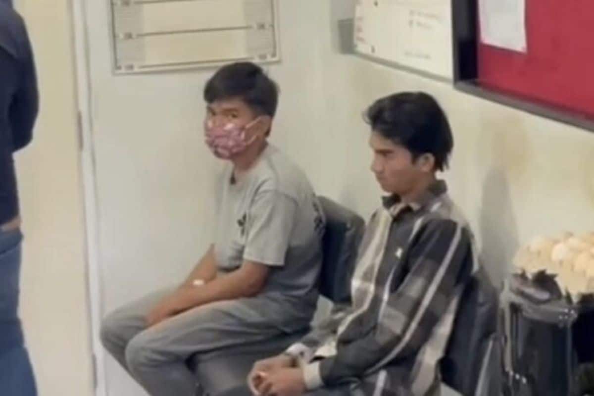 Police officers arrest Cambodian youths connected to a viral road incident in Rayong province