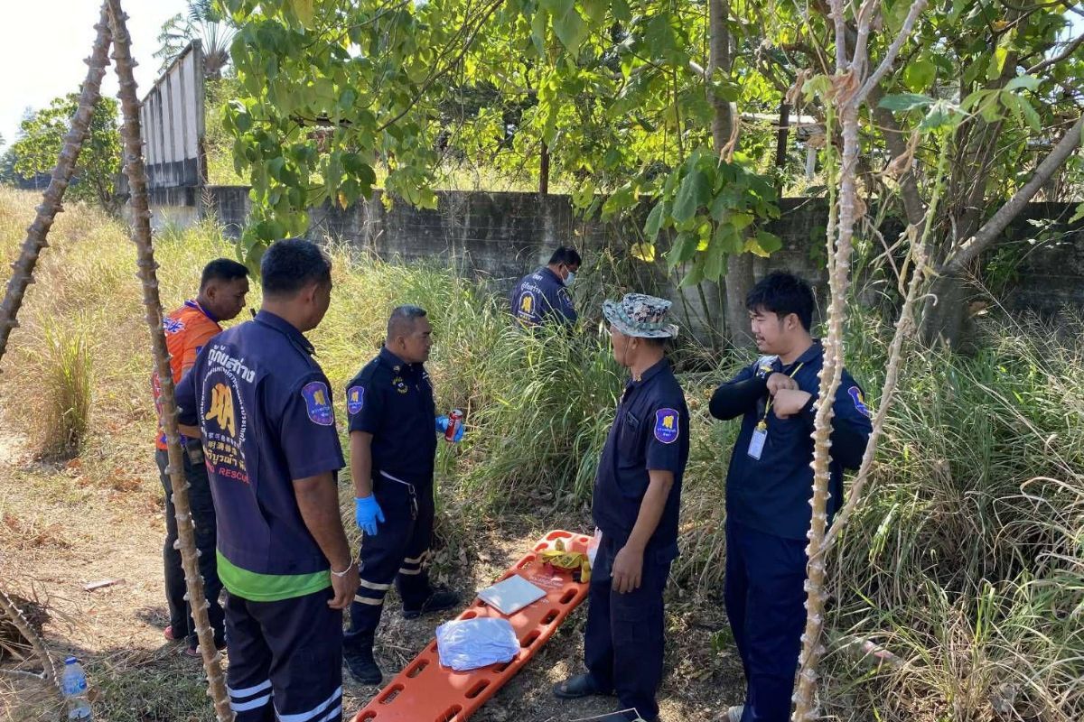 Rescue workers and police at the scene where a missing woman’s body was found in Chon Buri