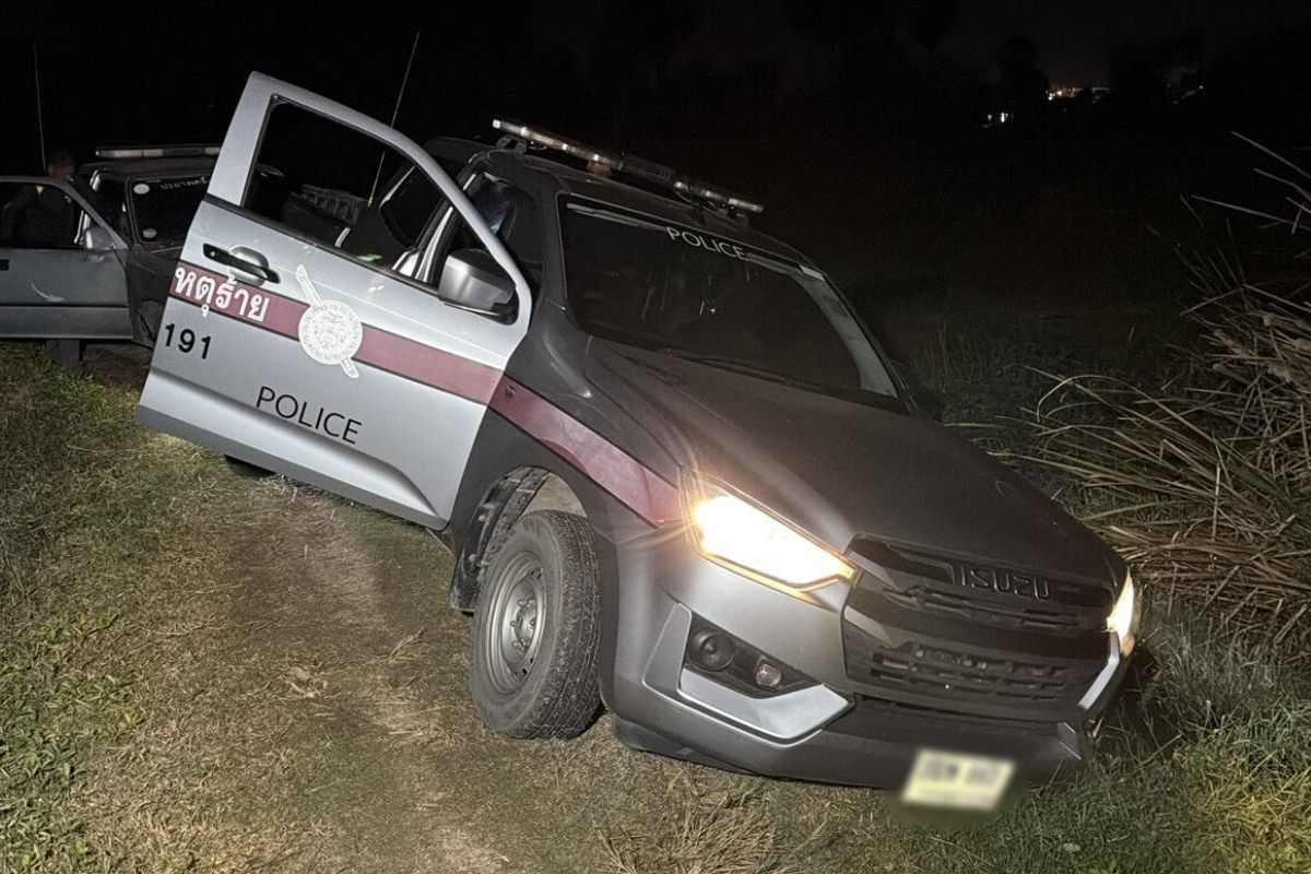 Police patrol car stuck off-road at a crime scene in Phetchaburi