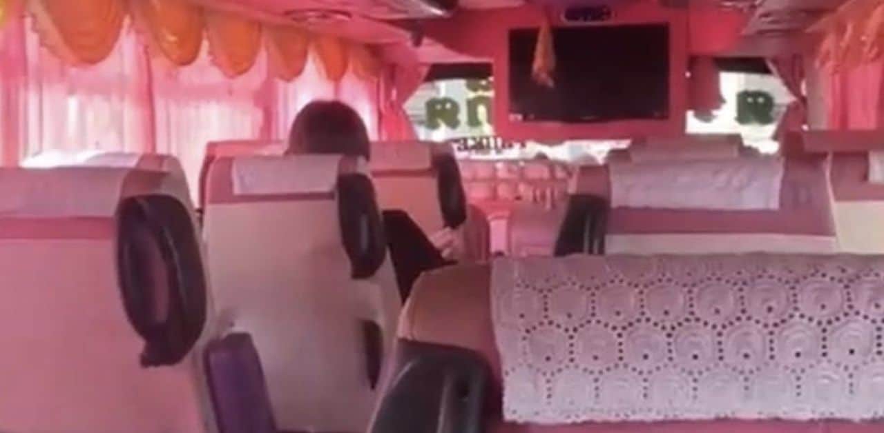 Indian places feet on coach bus seat