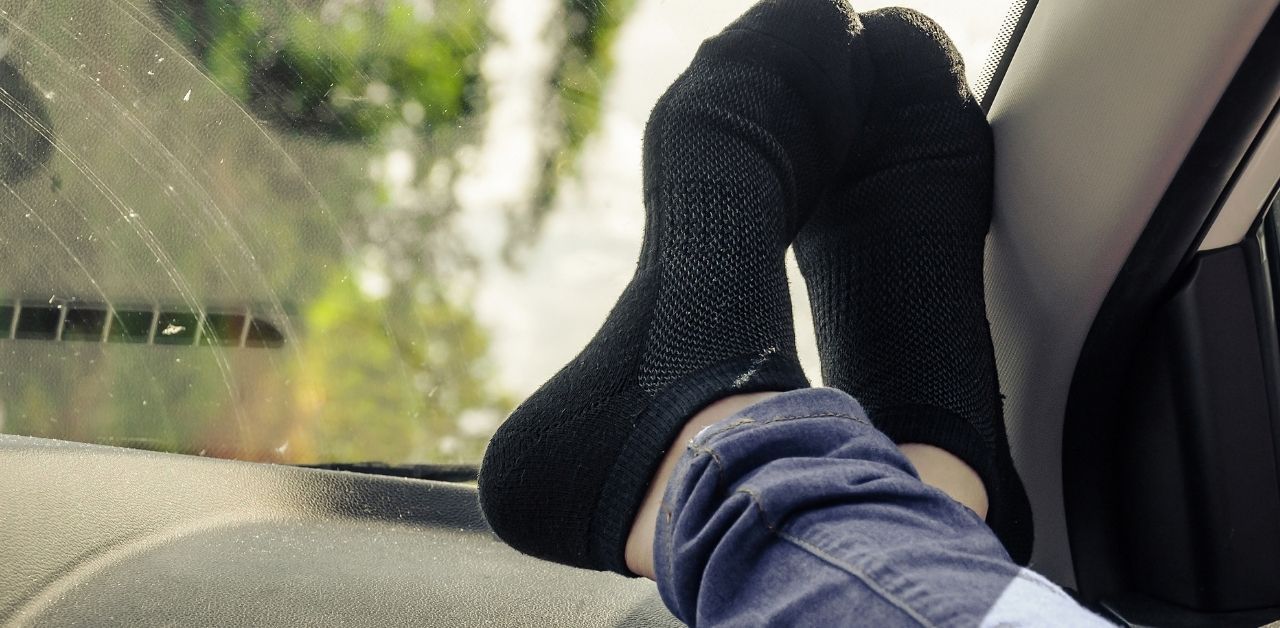 Feet on car dashboard