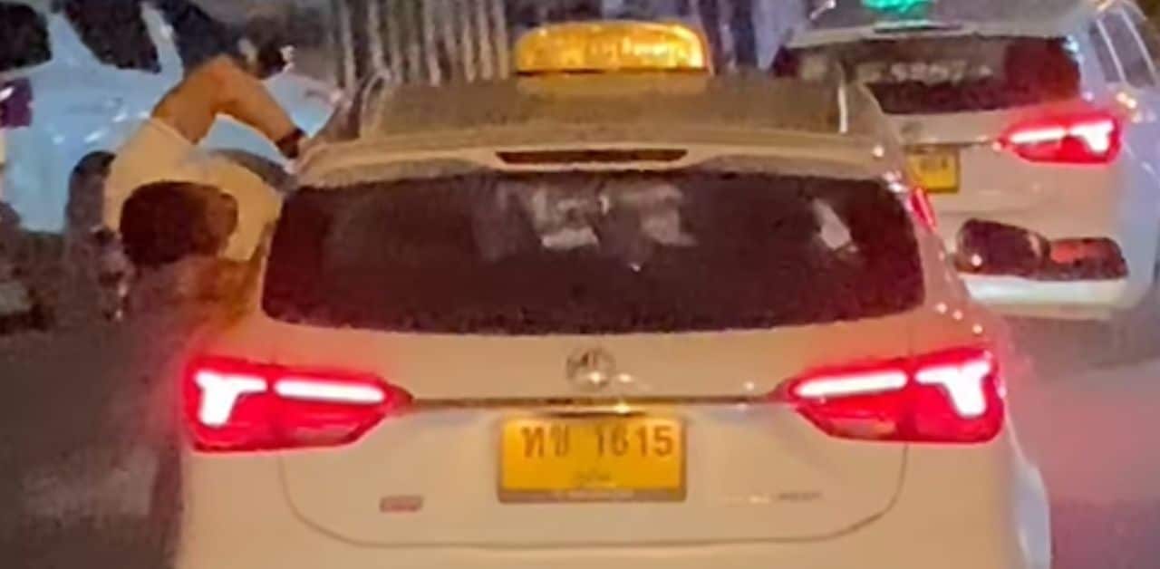 Foreign man slammed for leaning out of moving Phuket taxi | Thaiger