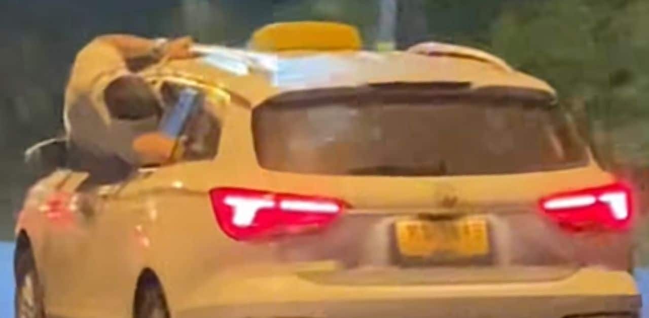 Foreigner gets upper body out of taxi window in Phuket