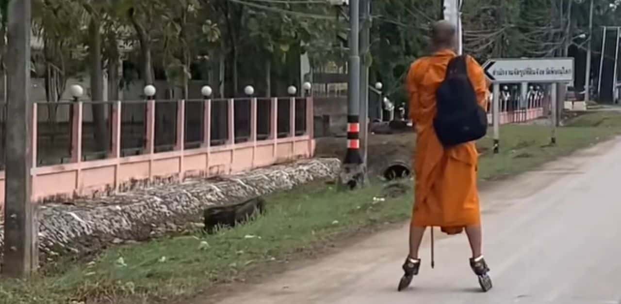 Monk skating along road in Phitsanulok