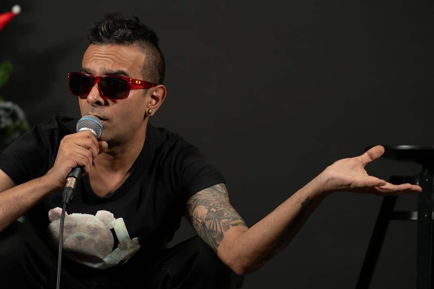 KC King on stage, exploring cultural identity through his Thai stand-up comedy routine.