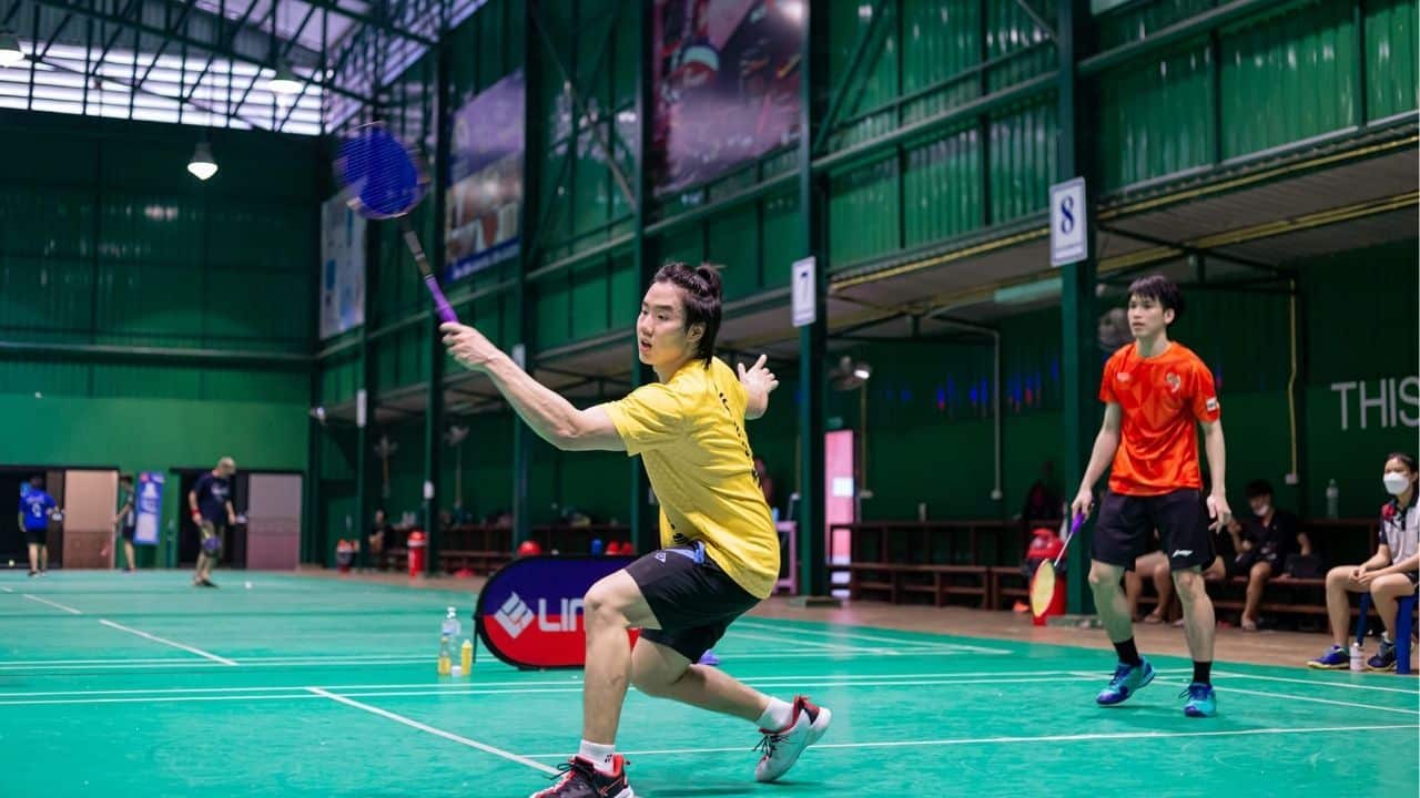 A public badminton court in Chiang Mai filled with players, demonstrating the sport's appeal among tourists and locals alike.