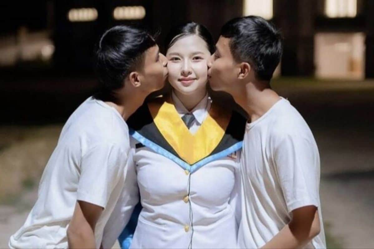 Thai woman Fah posing with her twin boyfriends, Sing and Suea