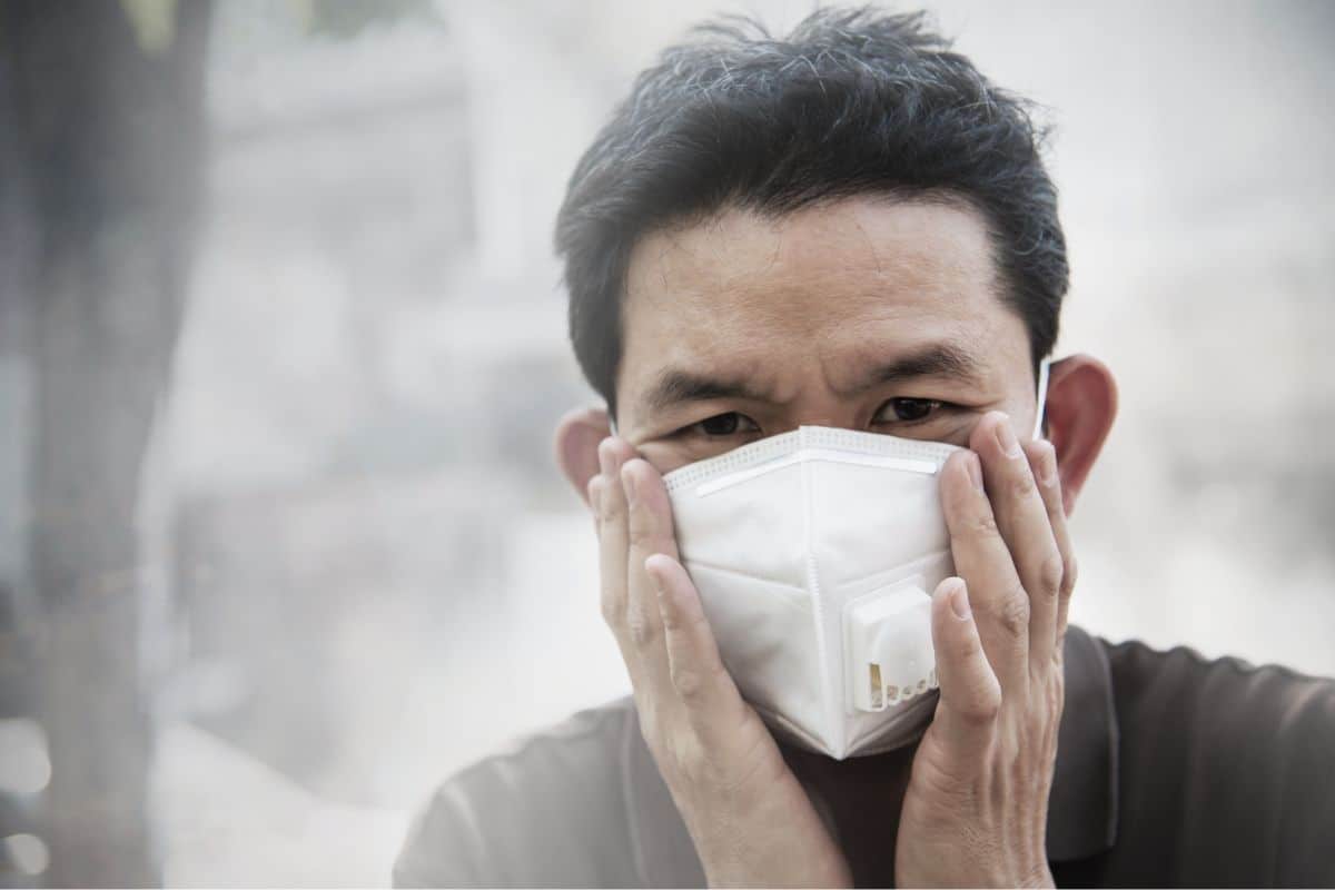 Man wearing face mask to protect against PM2.5 air pollution