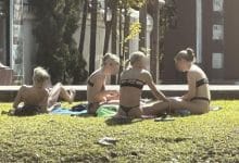Opinions divided after foreigners sunbathe in bikinis near Chiang Mai temple | Thaiger